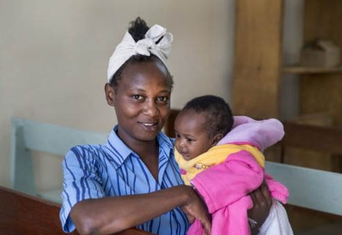 A mother holding her baby at a maternity clinic in Nairobi